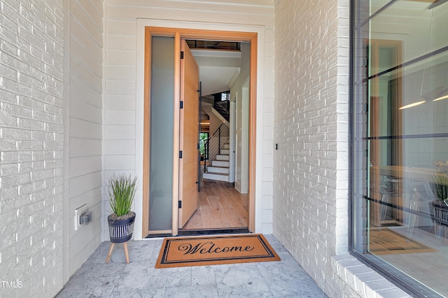 property entrance featuring brick siding