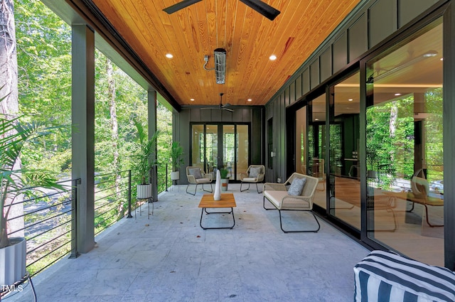 unfurnished sunroom featuring wooden ceiling and ceiling fan