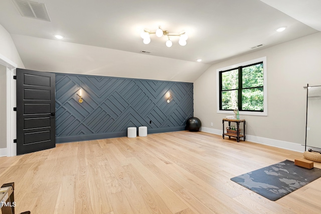 bonus room featuring lofted ceiling, baseboards, wood finished floors, and visible vents