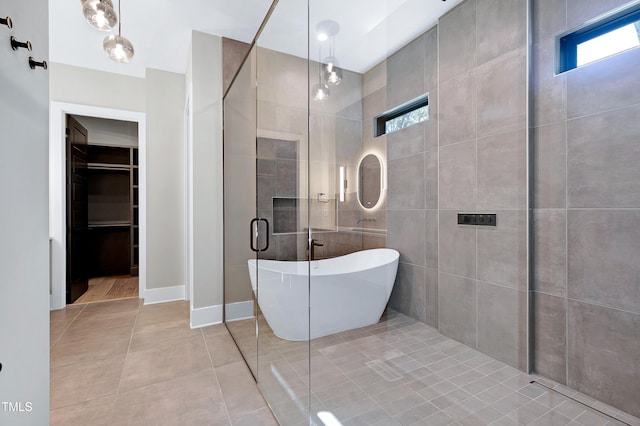 bathroom with tile walls, tile patterned floors, and plus walk in shower