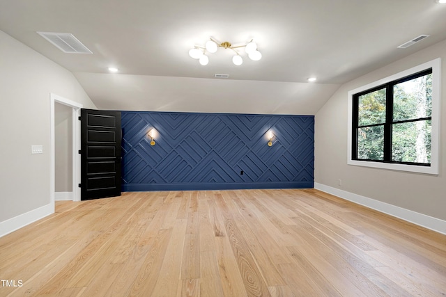 interior space with lofted ceiling and light wood-type flooring