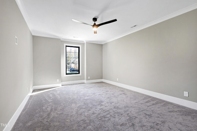 empty room with crown molding, carpet flooring, and ceiling fan