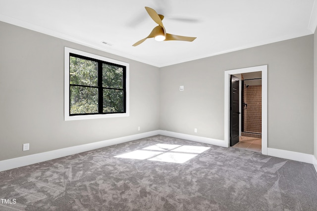 spare room with ceiling fan, ornamental molding, and light colored carpet