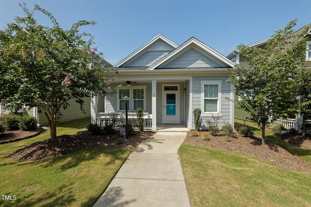 view of front of property with a porch and a front lawn