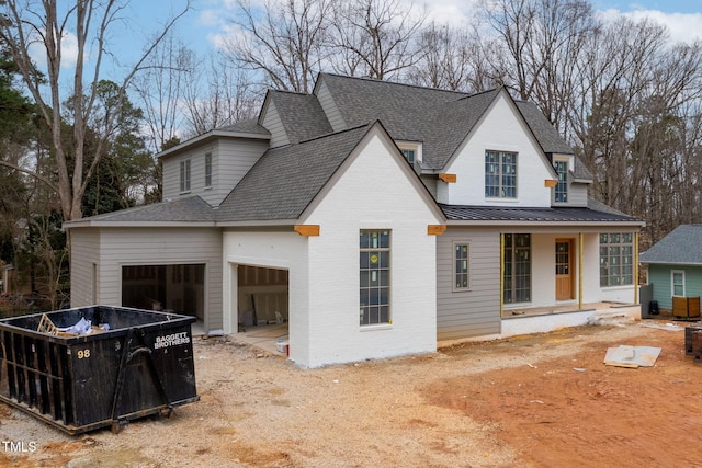 view of front of house featuring a garage and a porch