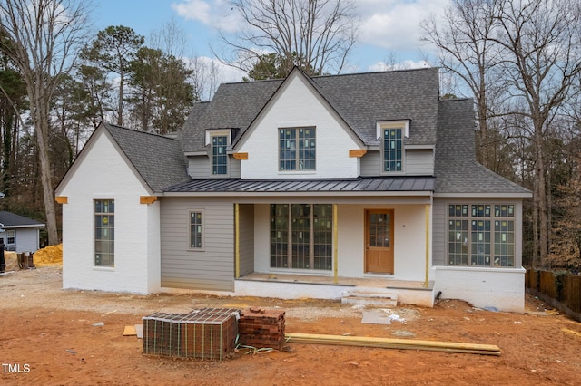 view of front of house featuring a porch and central air condition unit