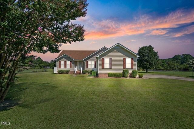 ranch-style home featuring a lawn