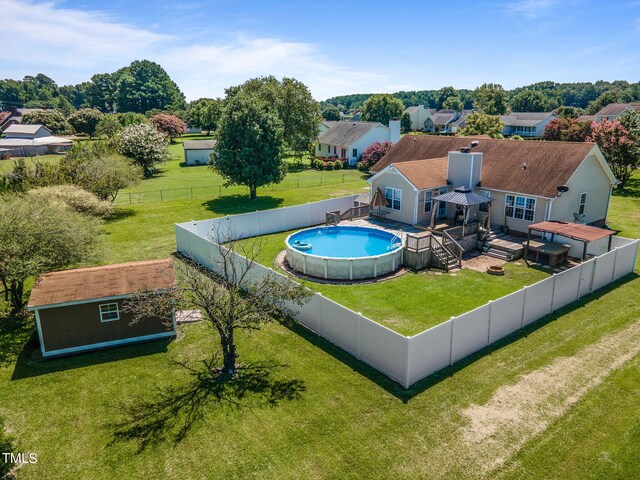 view of swimming pool featuring a wooden deck and a lawn