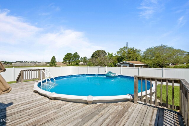 view of pool with a wooden deck