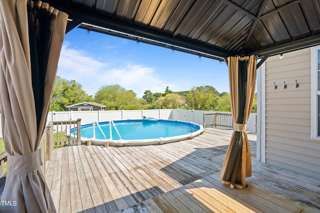 view of pool featuring a gazebo and a deck