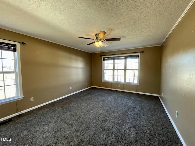 unfurnished room with dark colored carpet, ornamental molding, a textured ceiling, and ceiling fan