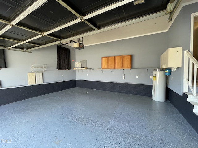 garage with a garage door opener and electric water heater