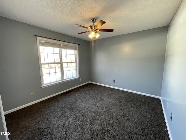 carpeted empty room with a textured ceiling and ceiling fan