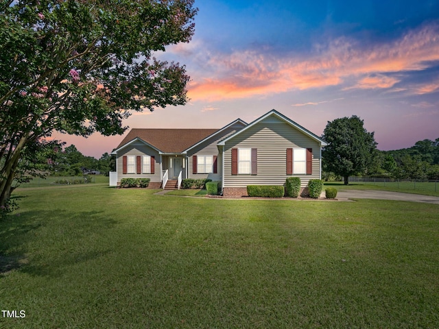 single story home featuring a yard