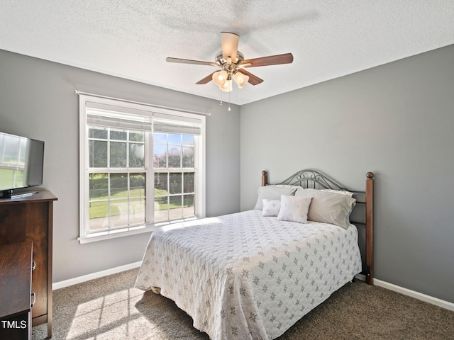 bedroom with ceiling fan, a textured ceiling, baseboards, and carpet floors