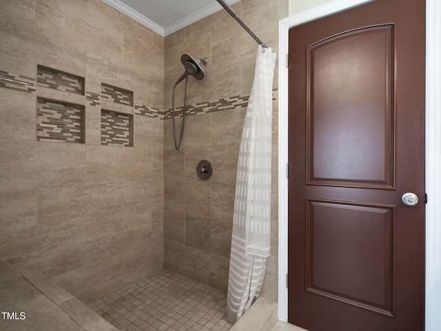 full bath with tiled shower and ornamental molding