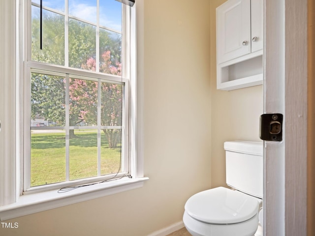 bathroom with baseboards and toilet