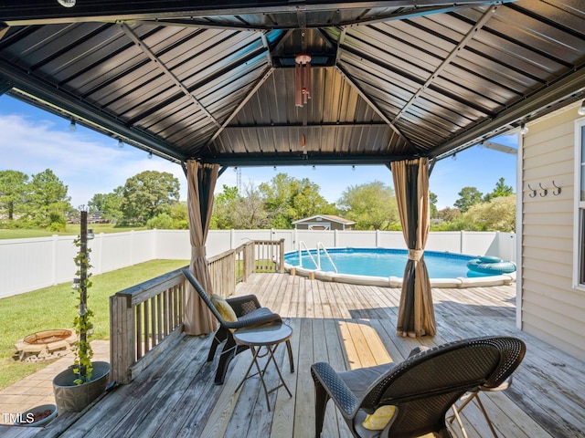 wooden deck with a gazebo, a fenced in pool, and a fenced backyard