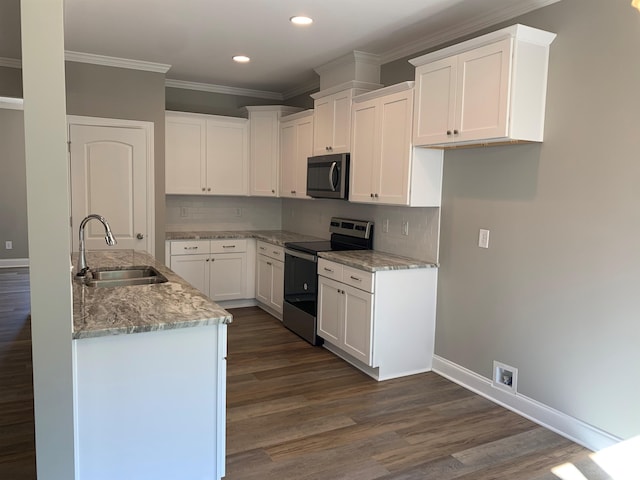 kitchen with dark wood-type flooring, backsplash, sink, and appliances with stainless steel finishes