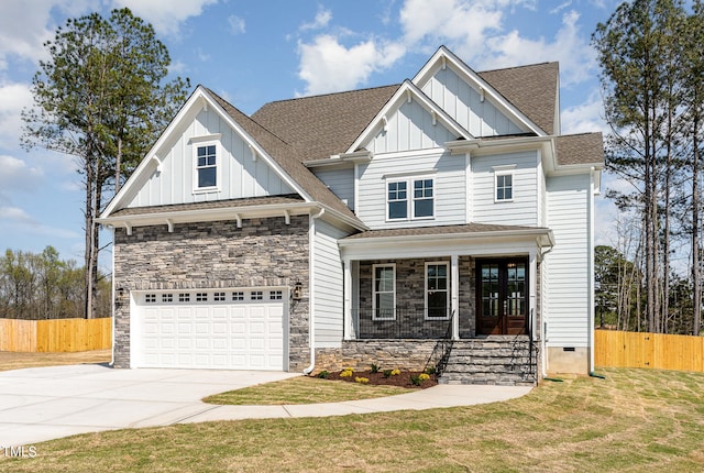 craftsman inspired home featuring covered porch, a garage, and a front lawn