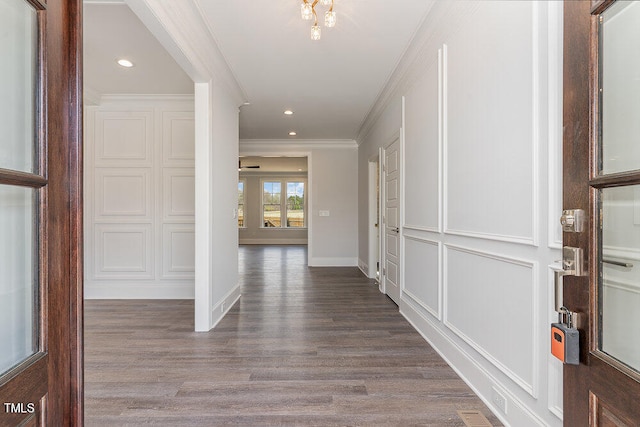 corridor featuring wood-type flooring and ornamental molding