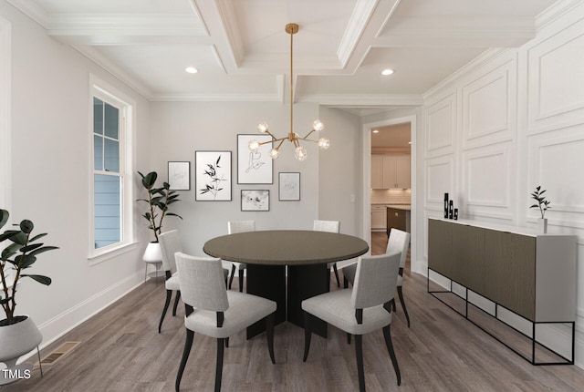 dining area featuring a chandelier, crown molding, wood-type flooring, and beam ceiling