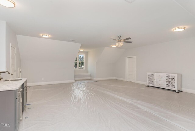 interior space with ceiling fan and sink