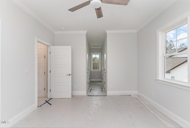 unfurnished bedroom featuring ceiling fan and crown molding