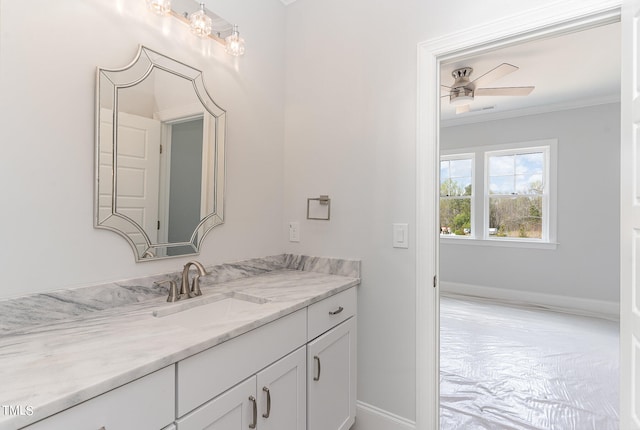 bathroom with vanity, ceiling fan, and crown molding