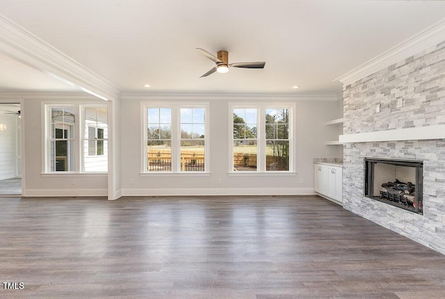 unfurnished living room with a fireplace, dark wood-type flooring, ceiling fan, and ornamental molding