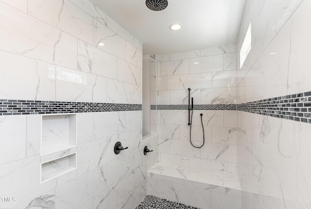 bathroom with recessed lighting and tiled shower