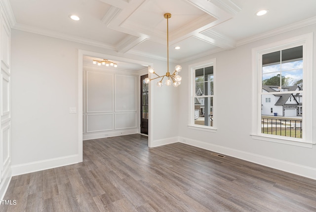 unfurnished dining area with a chandelier, wood-type flooring, crown molding, and coffered ceiling