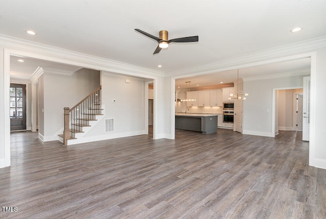 unfurnished living room with ceiling fan, dark hardwood / wood-style flooring, sink, and ornamental molding