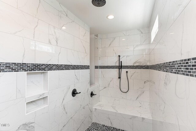 bathroom with tiled shower