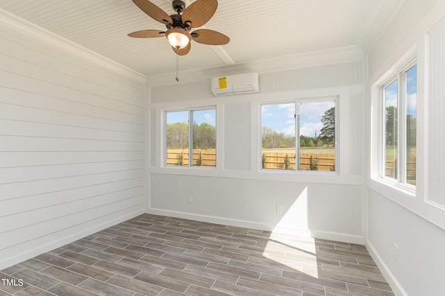 unfurnished sunroom with ceiling fan, a wealth of natural light, and a wall mounted AC