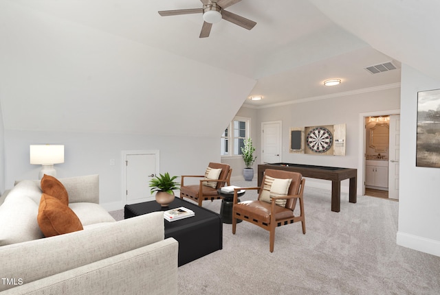 carpeted living room featuring vaulted ceiling, ceiling fan, and crown molding