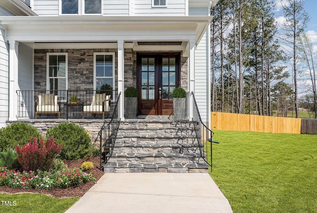 600 Darian Woods Dr, Holly Springs, NC 27540 - doorway to property with covered porch and stone siding