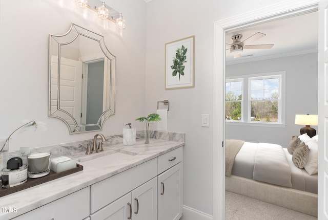 bathroom featuring ceiling fan, vanity, and ornamental molding