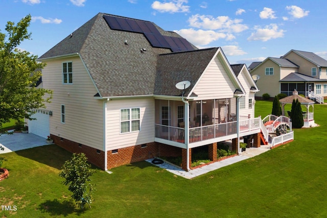 back of house featuring a sunroom, crawl space, roof with shingles, and a yard