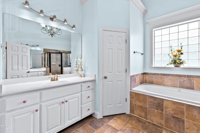 bathroom featuring vanity, a shower stall, a bath, and crown molding