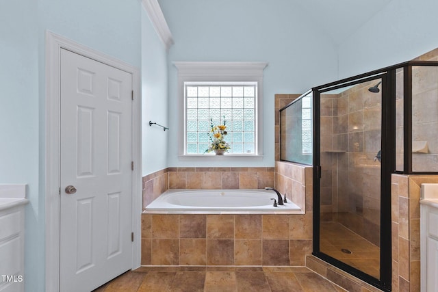 full bathroom with a stall shower, vanity, and a bath