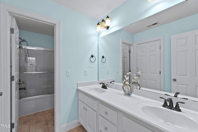 full bathroom with double vanity, tile patterned flooring, visible vents, and a sink