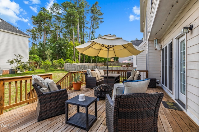 wooden terrace featuring an outdoor living space with a fire pit