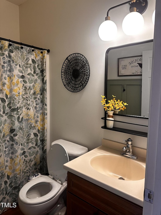 bathroom featuring vanity, toilet, and a shower with shower curtain