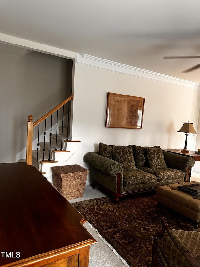 living room featuring carpet flooring, crown molding, and ceiling fan