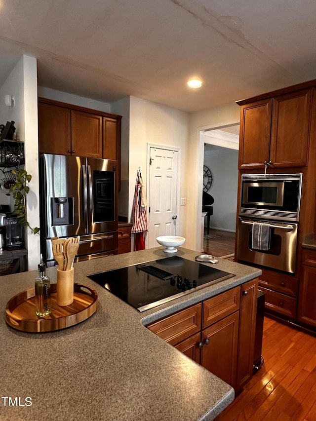 kitchen featuring appliances with stainless steel finishes and wood-type flooring