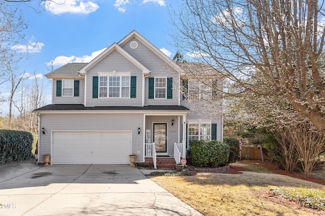 traditional-style home featuring a garage, concrete driveway, and fence