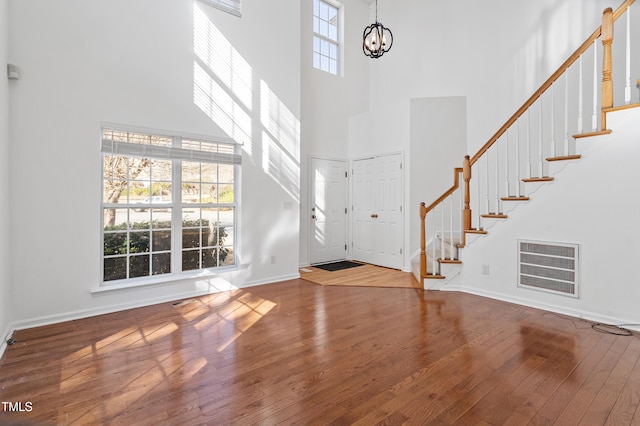 foyer featuring stairs, hardwood / wood-style floors, and a healthy amount of sunlight