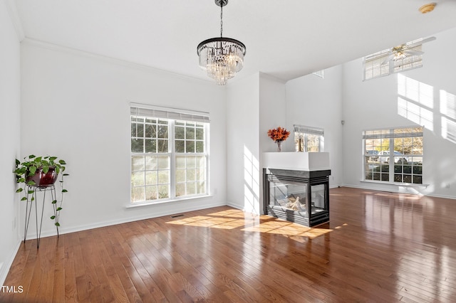 living area featuring plenty of natural light, hardwood / wood-style floors, and a multi sided fireplace