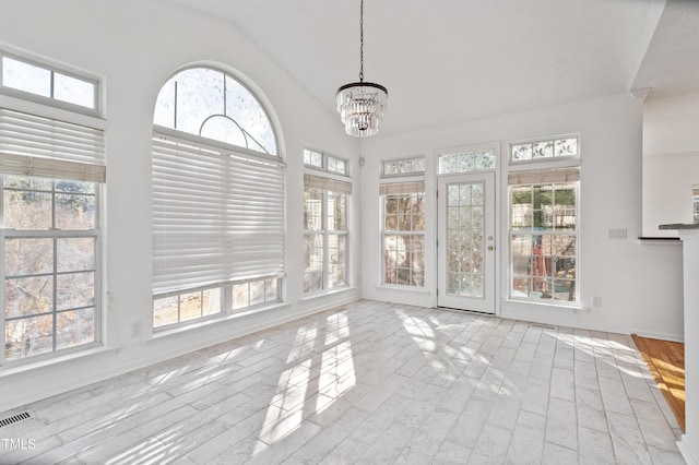 unfurnished sunroom with a chandelier, lofted ceiling, and visible vents